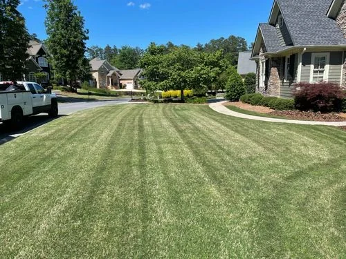 Crew truck and freshly mowed striped front yard — Charlottesville VA